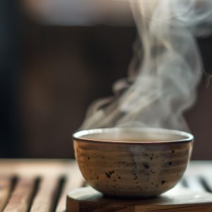 Steaming bowl on a wooden surface, evoking comfort and warmth