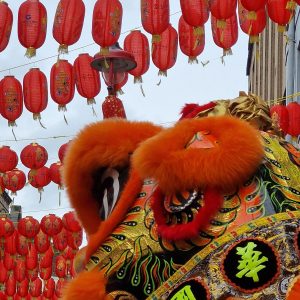 Lion dance and red lanterns during Lunar New Year celebrations in Chinatown, London.